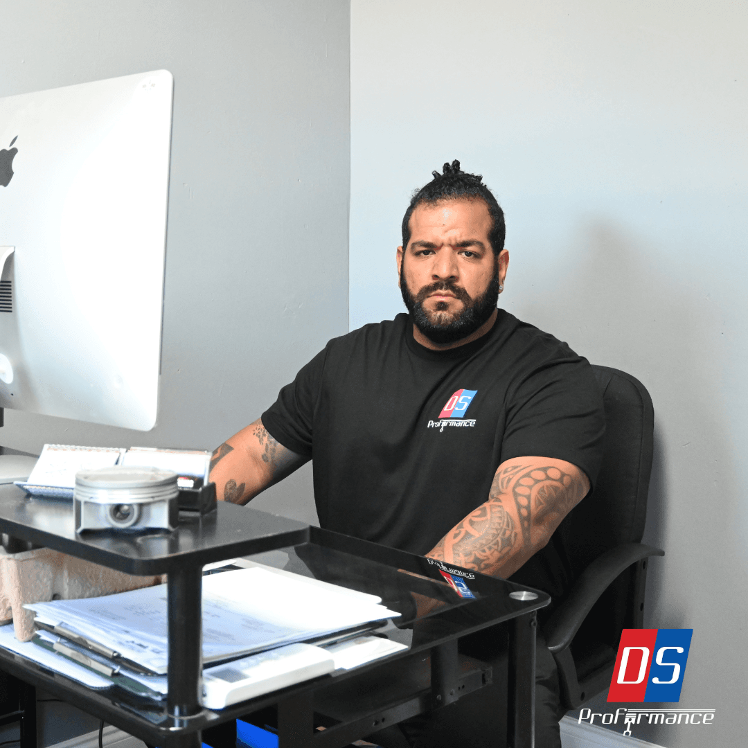 DS Proformance mechanic sitting at desk in office