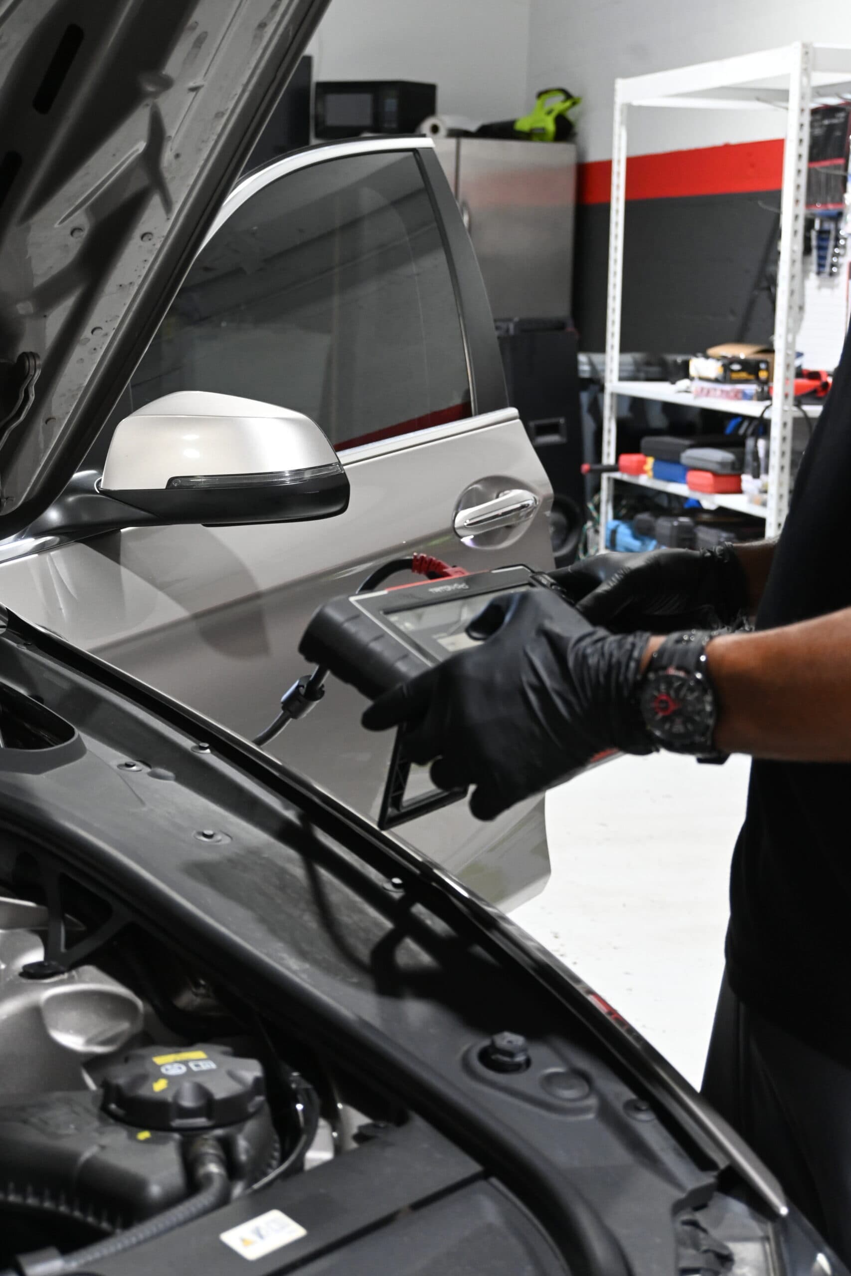 Mechanic using diagnostic scanner for car engine auto repair Mechanic using diagnostic scanner for car engine auto repair