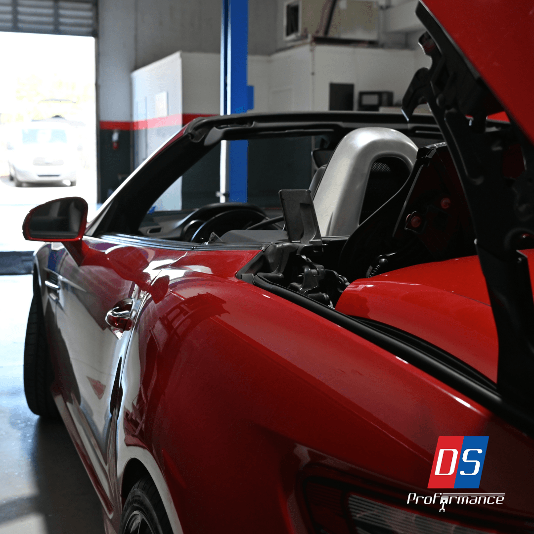 Red convertible sports car inside DS Proformance workshop Red convertible sports car inside DS Proformance workshop